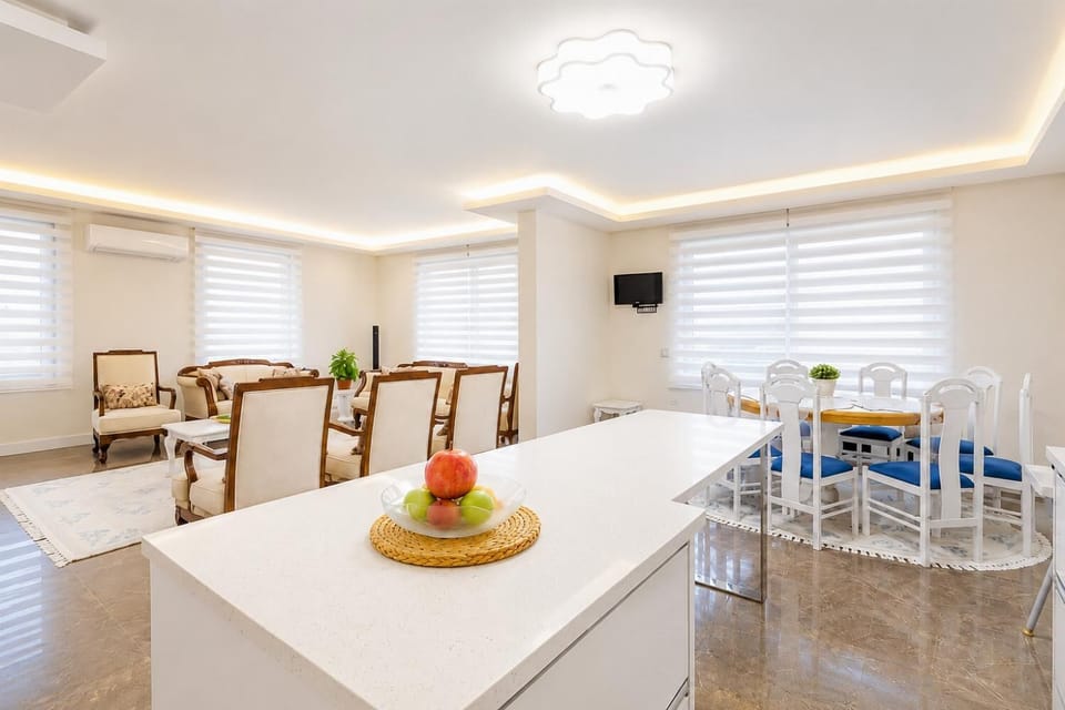 Open-plan living room with sofas, dining area, kitchen, A/C, WiFi internet, satellite TV, and pool terrace access