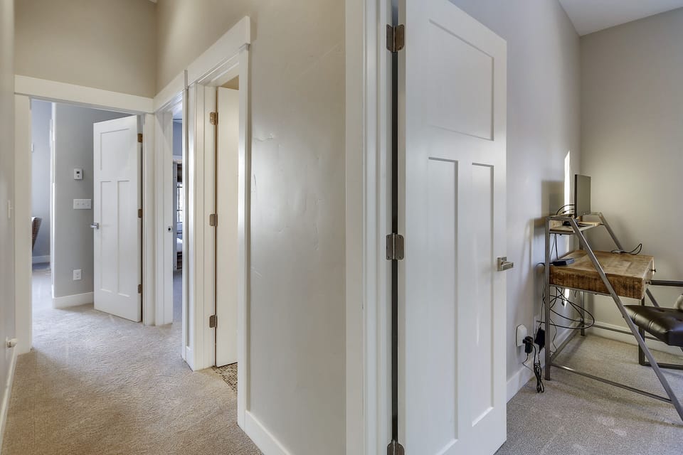 - Upstairs hallway connecting cozy bedrooms and modern bathrooms   - Spacious layout with clean bright design for family comfort   - Ideal setup for Colorado ski rental with multiple guest rooms