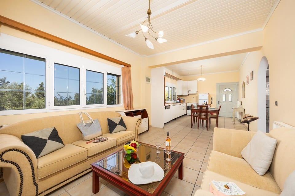 Ground floor unit: open-plan living room with sofas, dining area, kitchen, WiFi internet, and satellite TV