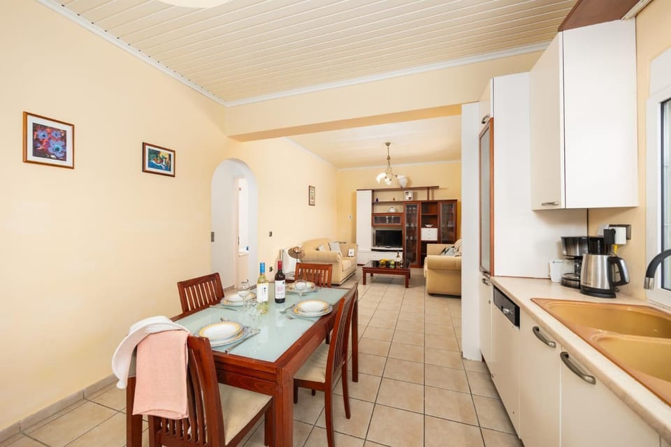Ground floor unit: open-plan living room with sofas, dining area, kitchen, WiFi internet, and satellite TV