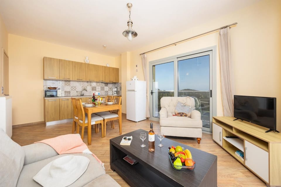 First floor unit: open-plan living room with sofa, dining area, kitchen, WiFi internet, and satellite TV