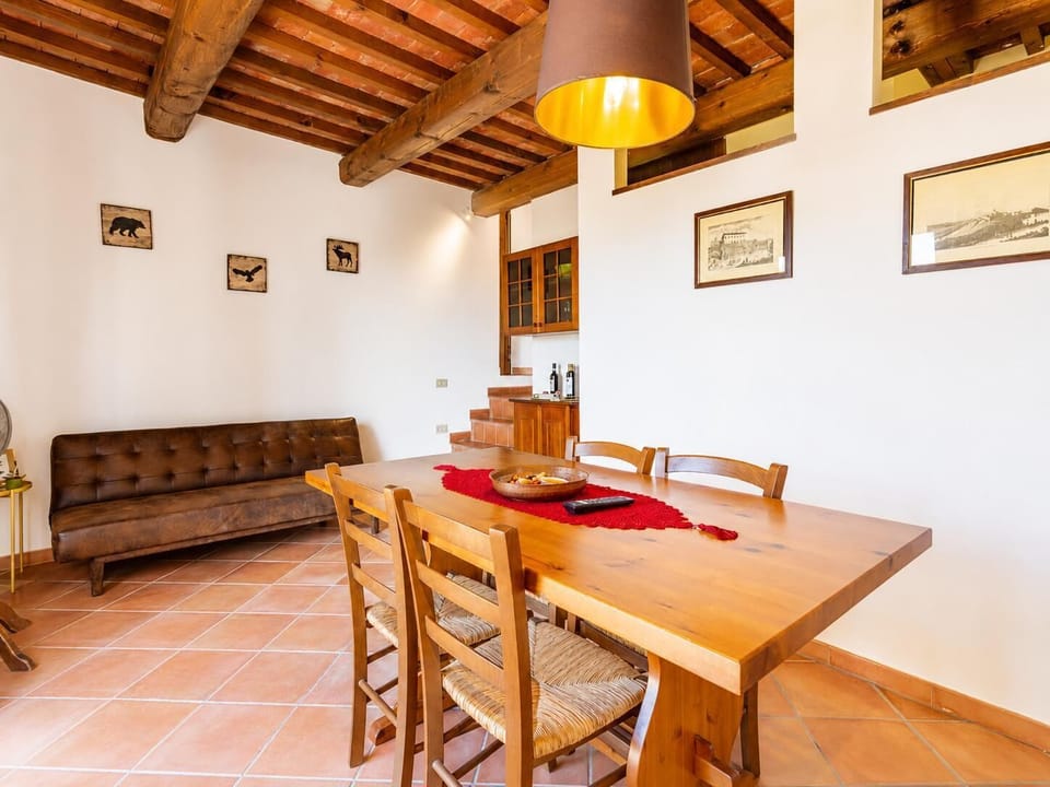 Living room with sofa, dining area, kitchen, WiFi internet, satellite TV, and terrace access