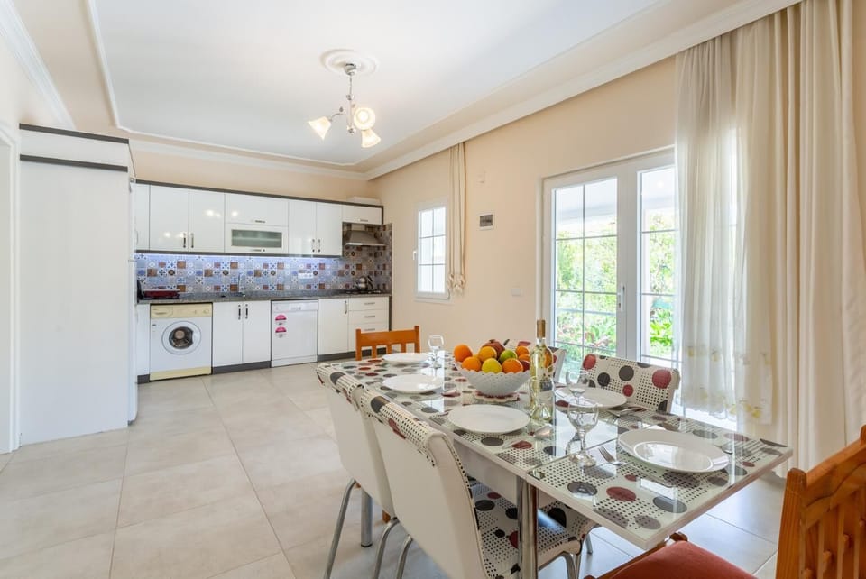 Open-plan living room with sofas, dining area, kitchen, A/C, WiFi internet, satellite TV, and terrace access