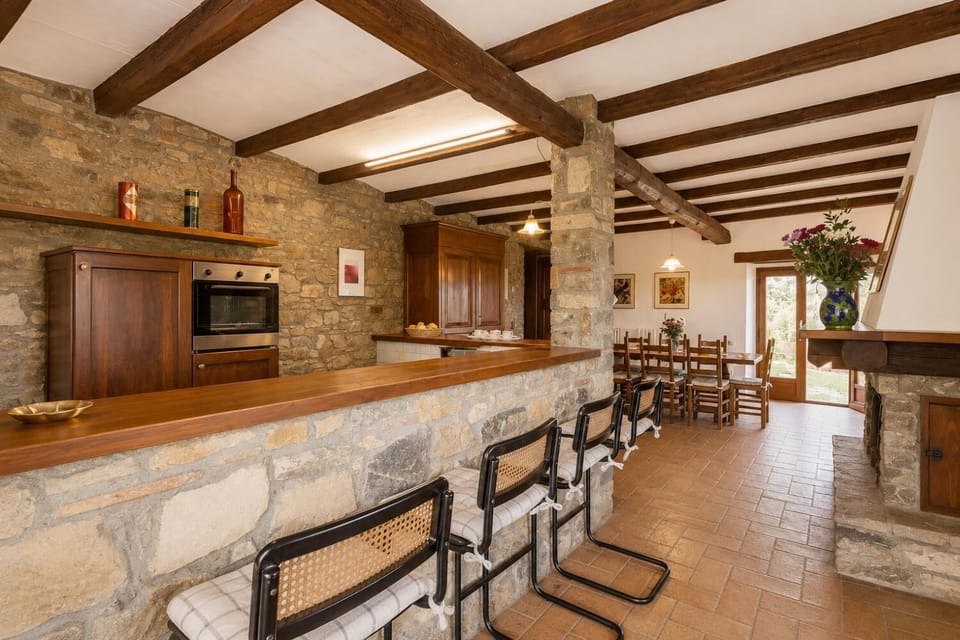 Open-plan dining area with equipped kitchen and ornamental fireplace