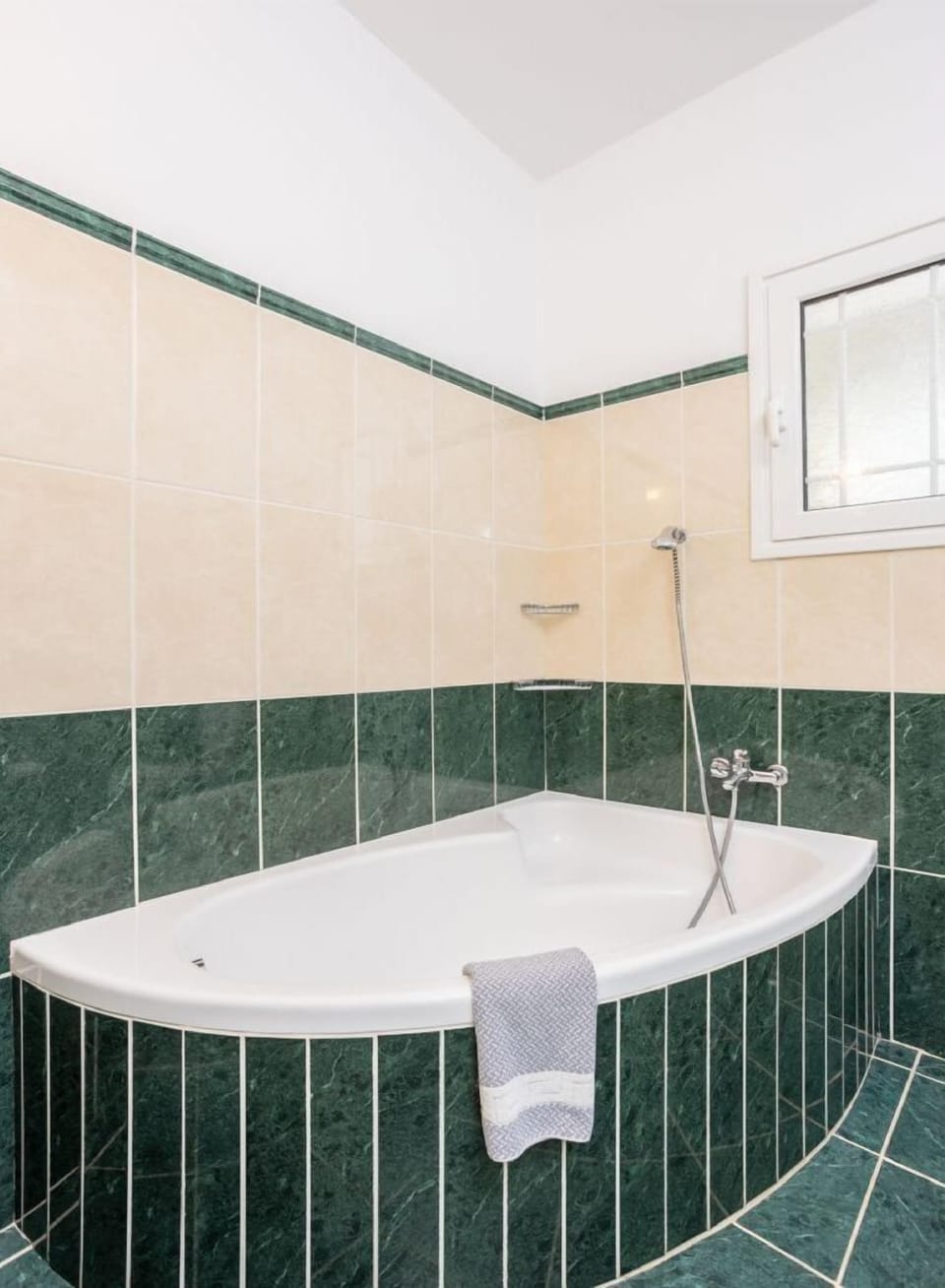 En suite bathroom with bath and shower
