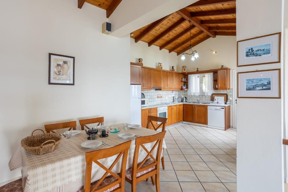 Open-plan living room with sofas, dining area, kitchen, ornamental fireplace, WiFi internet, satellite TV, and sea views