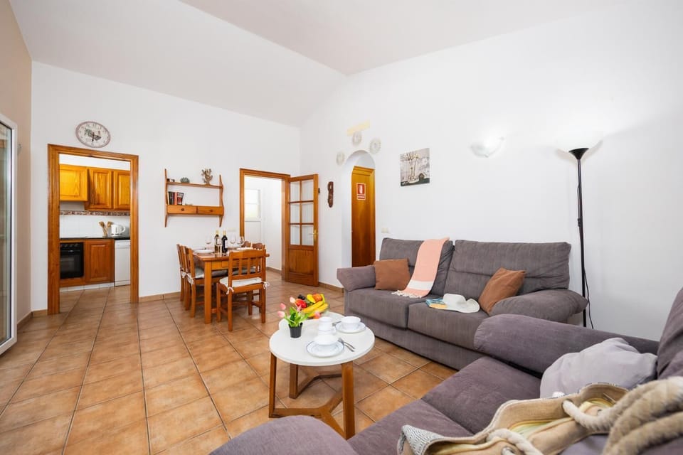 Living room with sofa, dining area, WiFi internet, and satellite TV
