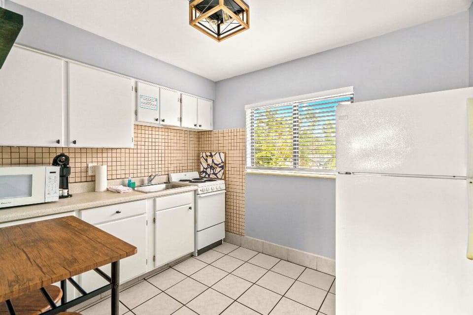 Boutique Beach Retreat kitchenette, microwave, stove/oven, refrigerator/freezer, coffee maker, kitchen basics, table and chairs