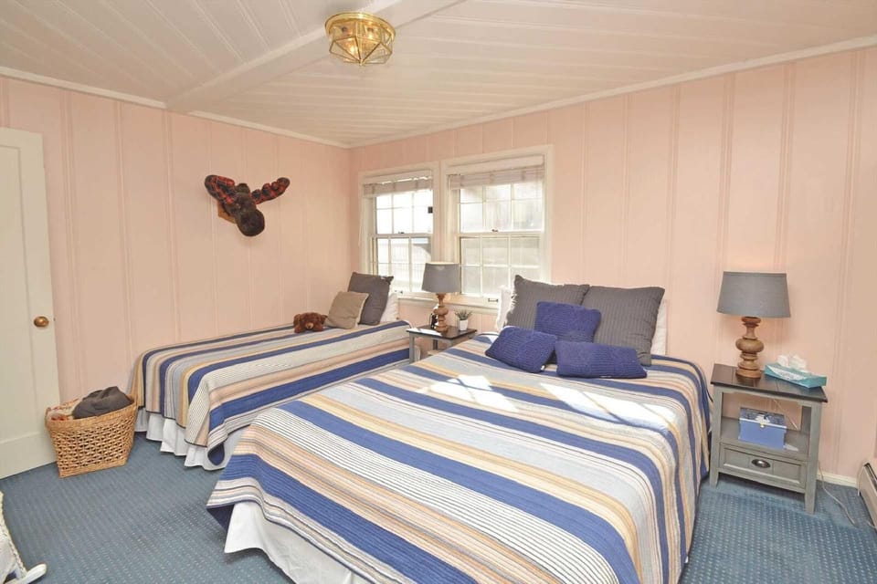 This room offers a queen bed and a twin bed, providing versatile sleeping options for a restful night