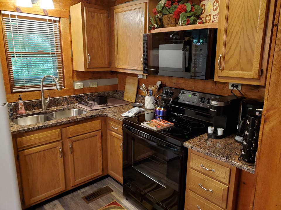 Newly renovated kitchen with granite countertop and double basin sink.