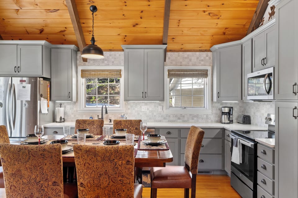 Spacious top of the line kitchen and dining area with stainless appliances.