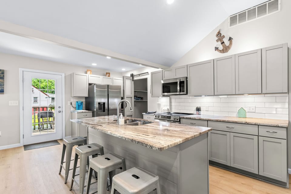 Bright modern kitchen with large island seating and stainless appliances