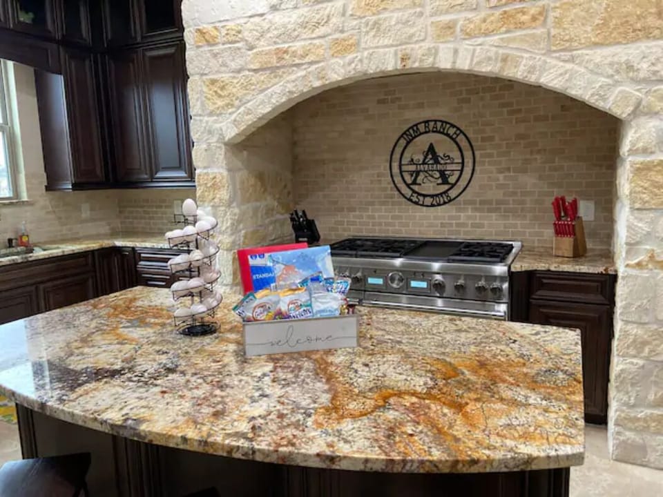Kitchen equipped with commercial Thermador appliances and three ovens. 