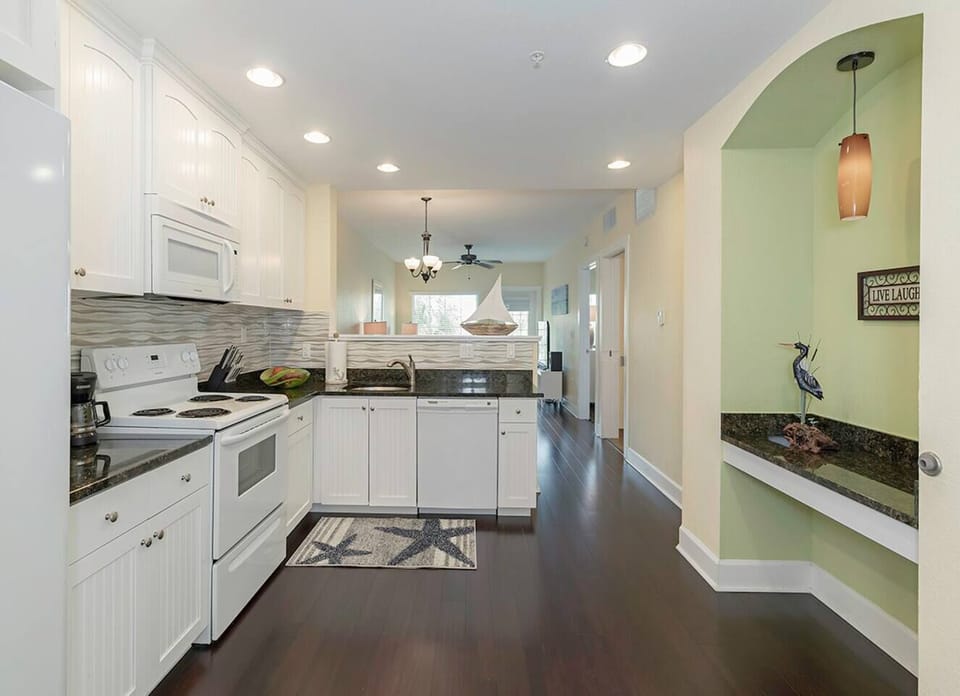 The kitchen - microwave, dishwasher, full size fridge, pots/pans, dishes and a Mr. Coffee