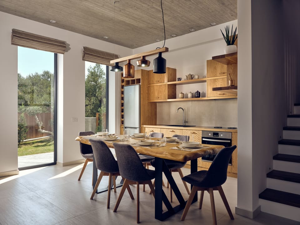 Open shelves in the kitchen flaunt stylish crockery & a dinning spot to long for