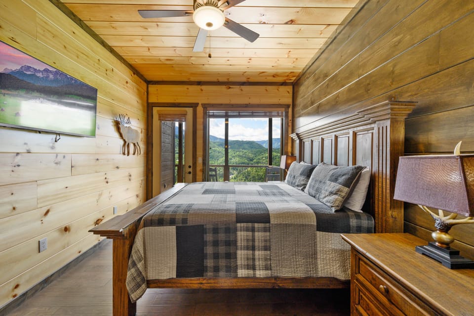 King bedroom with mountain views and direct deck access