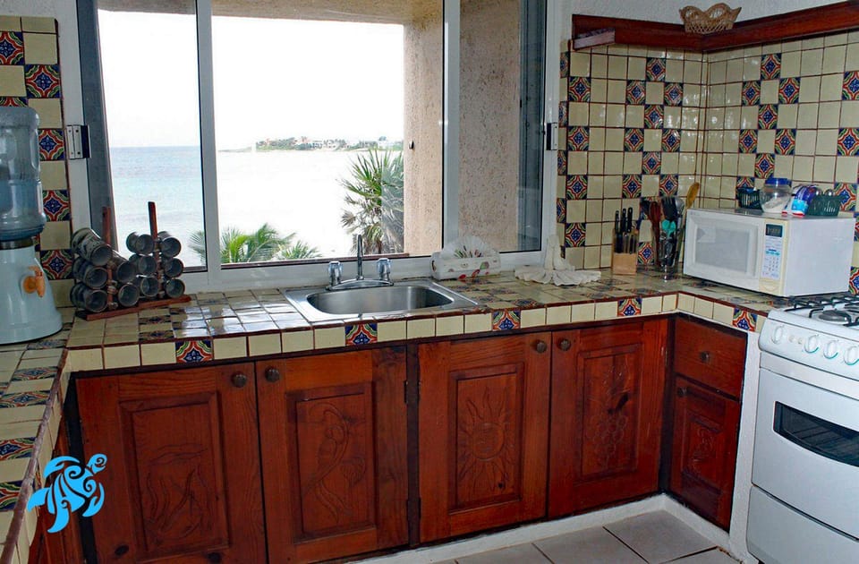 The Large Kitchen with It's Carved Cabinets and Talavera Tile