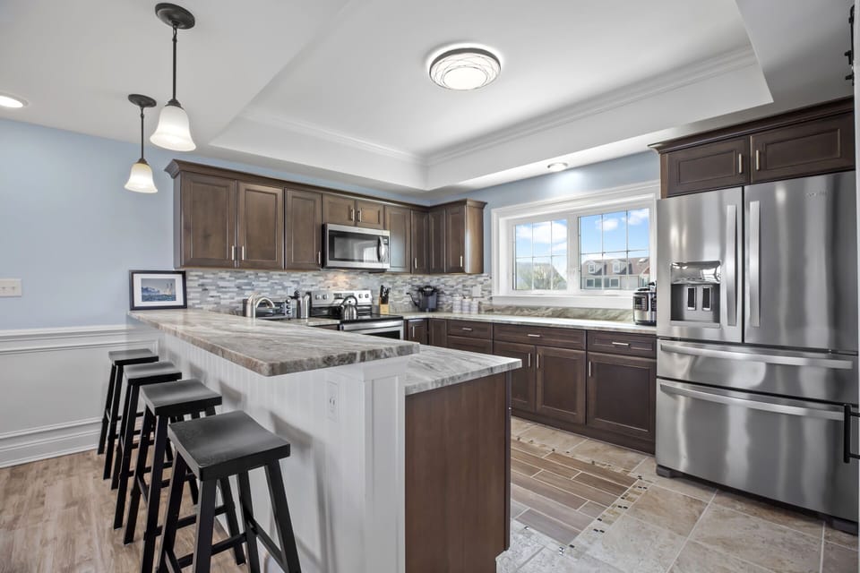 The Gourmet Kitchen has Custom Tile and Granite Countertops.
