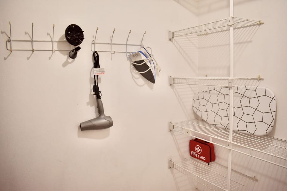 Main walking closet, Equipped with iron, hair blower, and ironing board. 