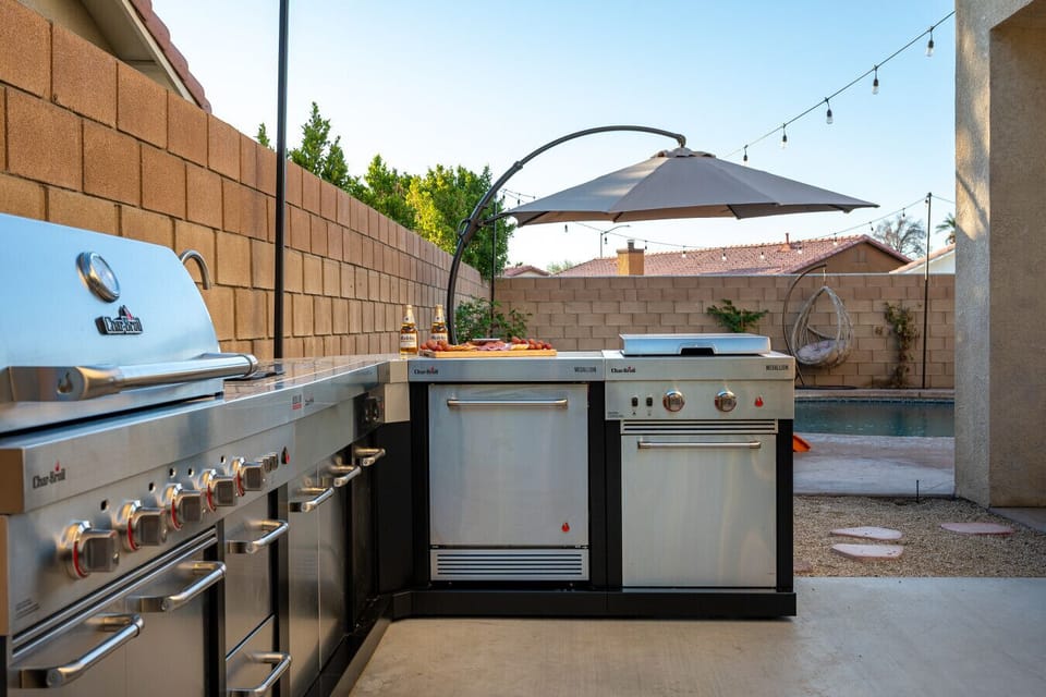 BBQ side: brand new stainless steel kitchen island with grill, sink, stove top