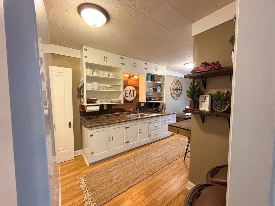 Modern and efficient—everything you need to create a delicious meal. The kitchen features a stainless steel refrigerator, stove, coffee maker, kitchenette oven, kettle, and blender