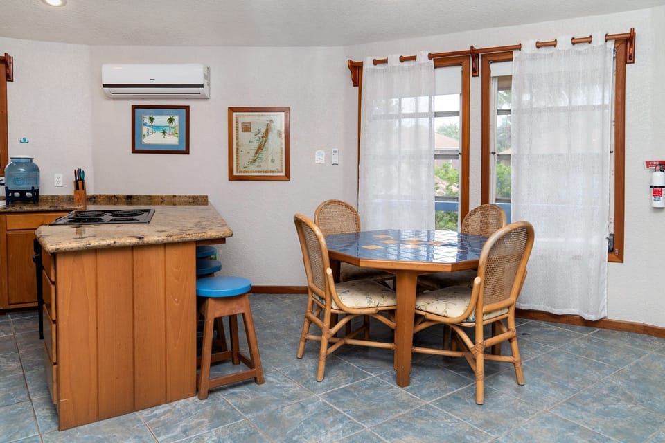 Dining table with seating for 4 and additional nearby Kitchen bar stool seating