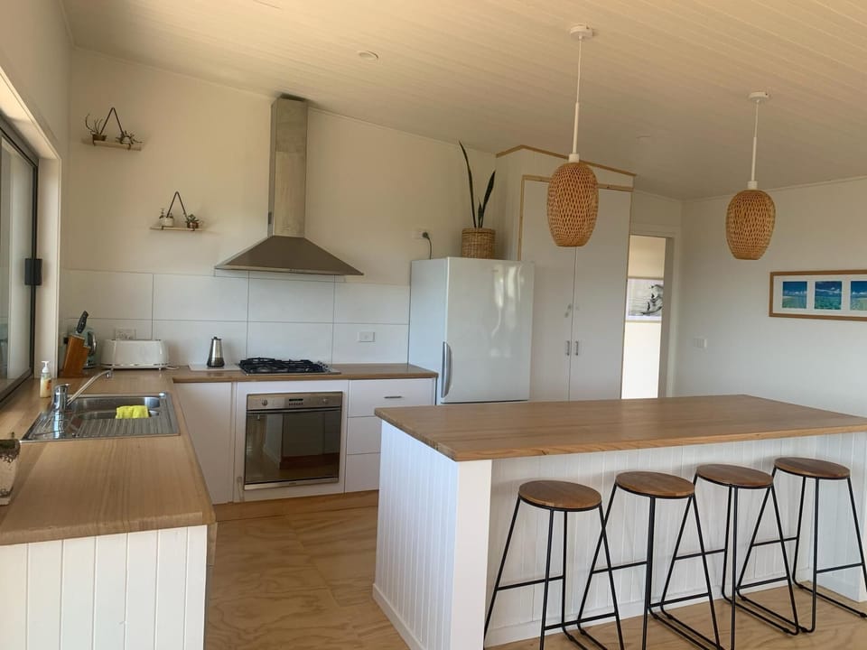 Large well equipped kitchen with island bench.