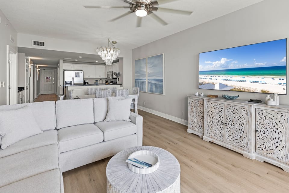 Unwind in your bright living space with beach views on the TV while soft coastal breezes flow from your ceiling fan.