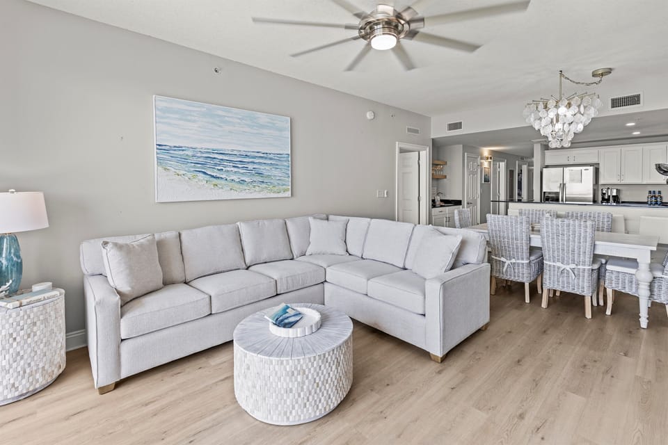 Sink into plush coastal comfort where your spacious sectional faces ocean artwork, while the open kitchen awaits your culinary adventures.