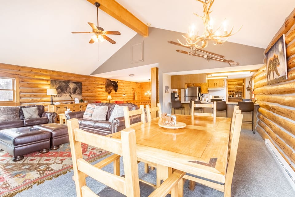Relax in your rustic log cabin retreat with soaring ceilings, cozy leather seating, and a full kitchen for memorable mountain getaways.