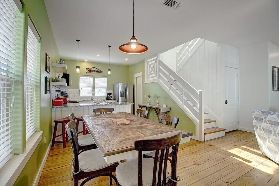 Gather around your rustic dining table in this bright, open-concept space where cooking and conversation flow naturally together.