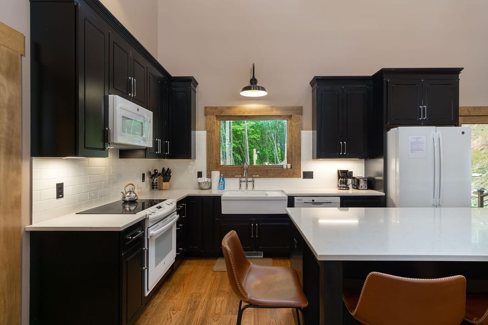 The fully-equipped kitchen features quartz countertops.