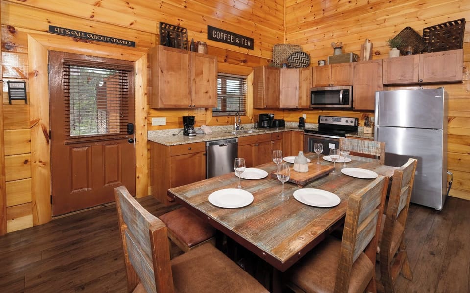 Cozy kitchen setup with dining table, granite counters, and modern appliances.