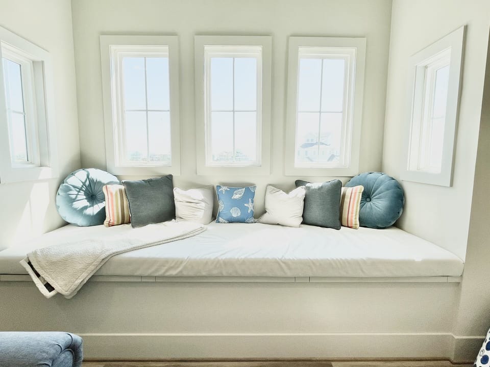 Extra large window bench/day bed in game room.