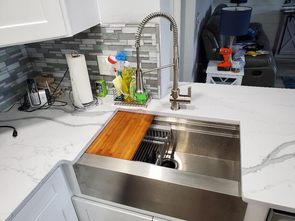 Wonderful deep stainless Farm sink and high end arch faucet with spray.