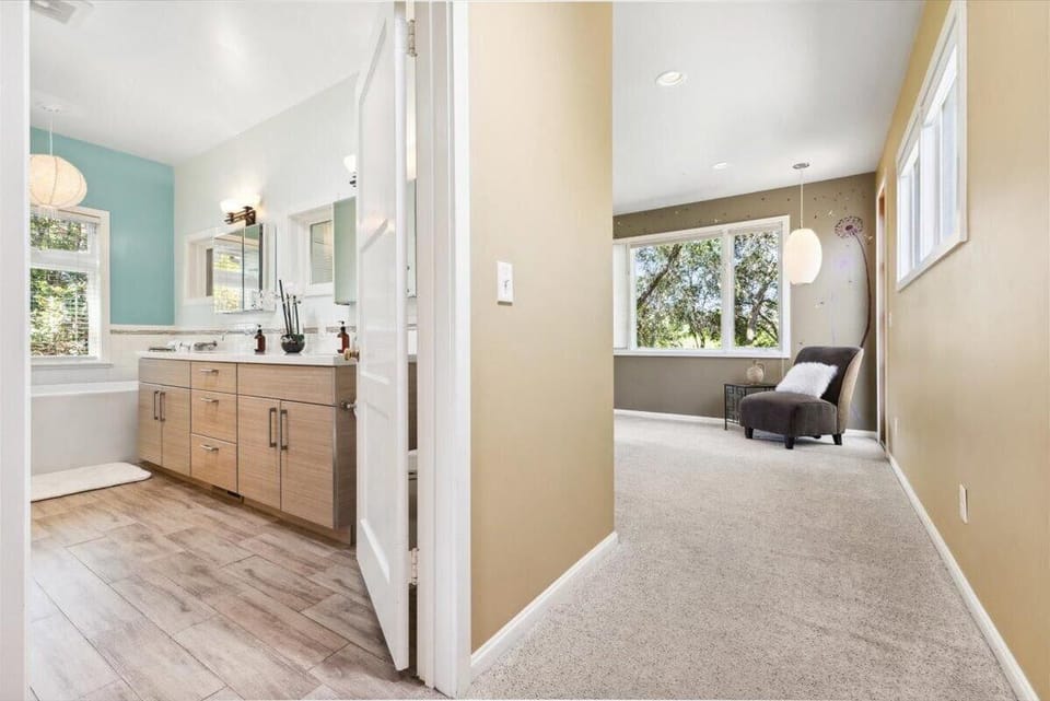 Main House En-Suite - Bright, airy hallway leading to a cozy sitting nook and spacious bathroom
