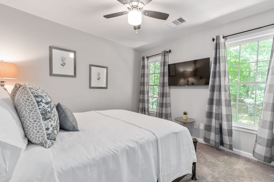Upstairs queen bedroom with 42 inch smart TV and closet.