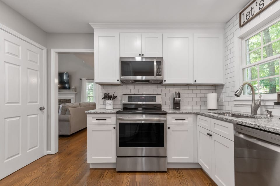 Kitchen with doorway to finished basement and two car garage.