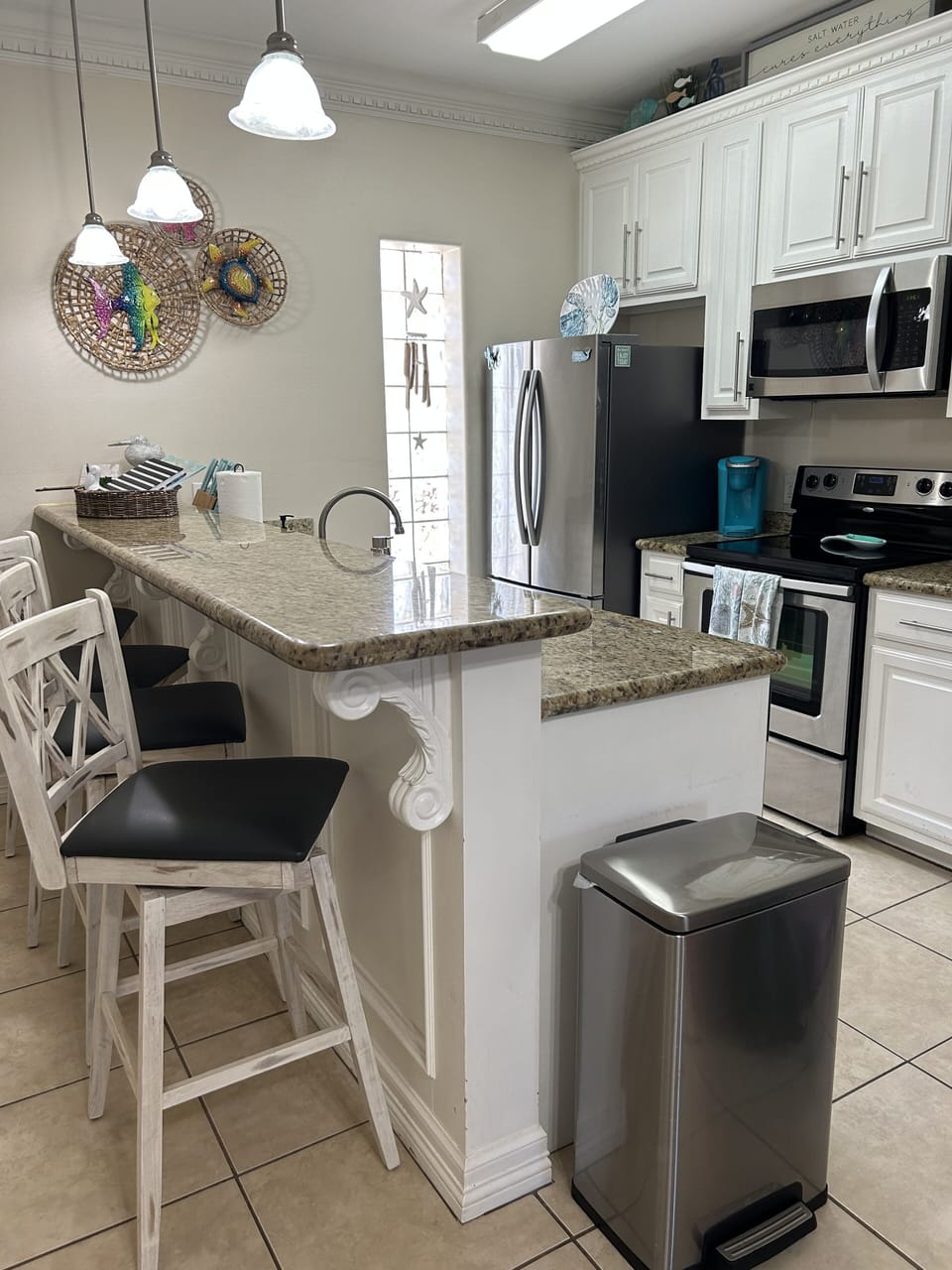 Kitchen with 4 bar stools for additional seating.