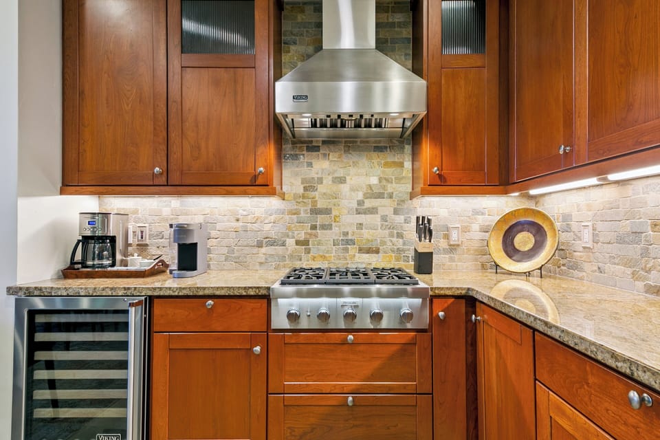 Your gourmet kitchen features rich wood cabinets, granite counters, and professional-grade appliances perfect for creating memorable meals.