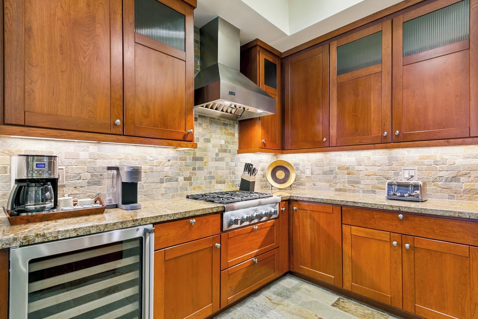 Step into your gourmet kitchen with rich wood cabinets, granite counters, and premium appliances ready for your culinary adventures.