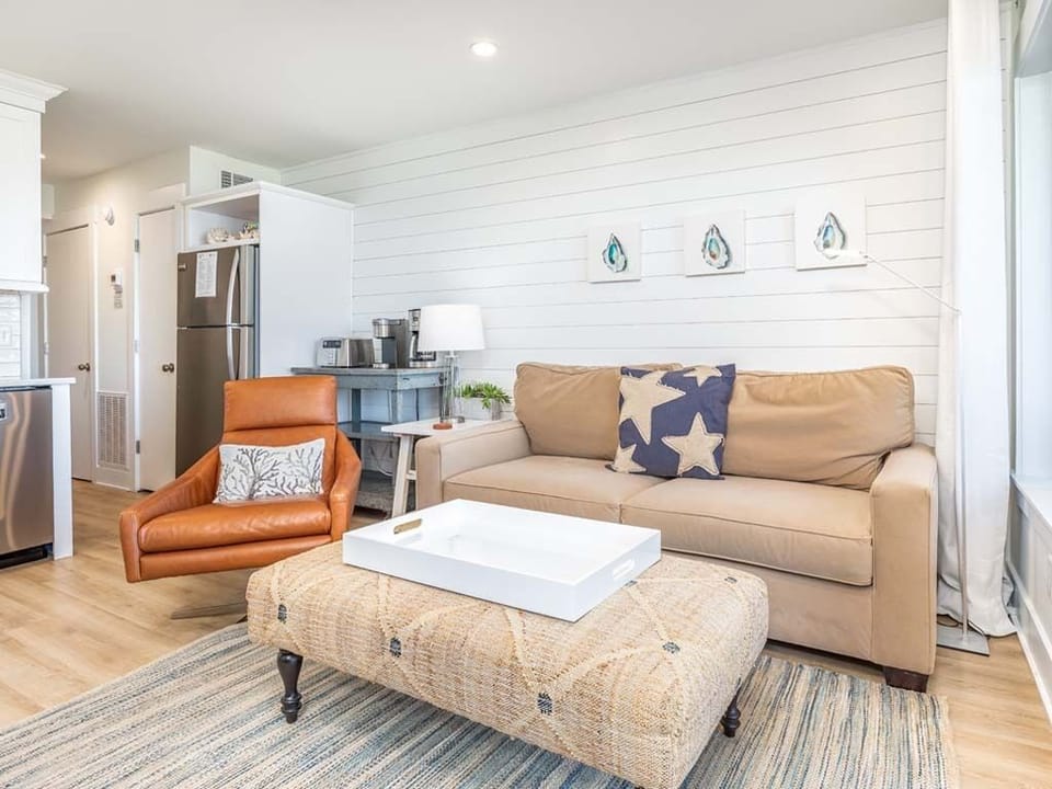 Living area with sleeper sofa and Smart TV, and attached balcony