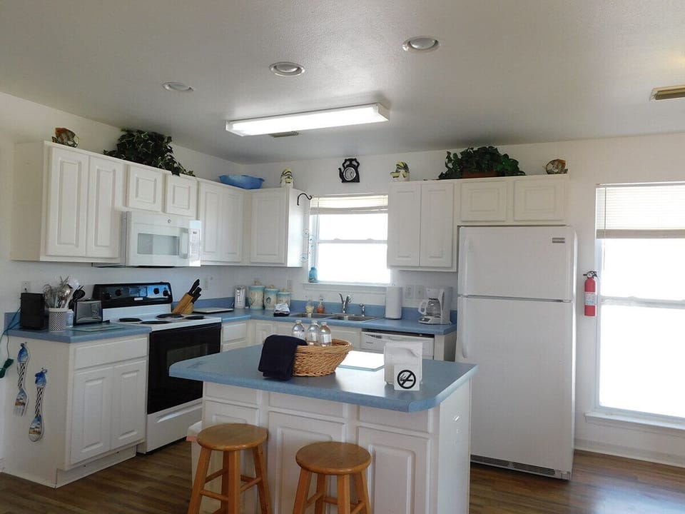 Spacious Kitchen with Over the Stove Microwave. Refrigerator includes Ice Maker.