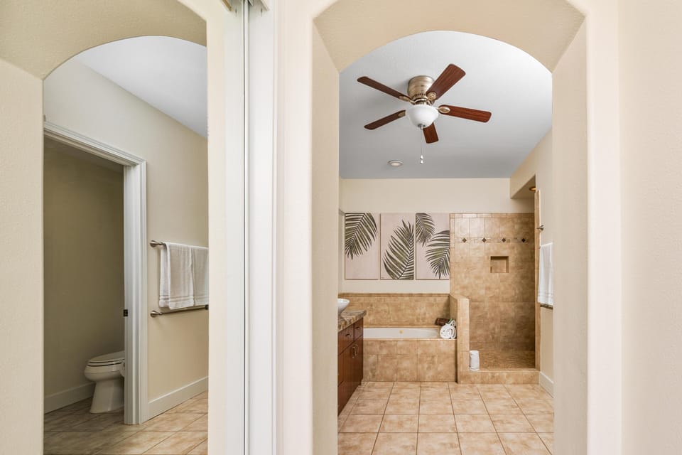 Primary bathroom with double vanity, walk-in shower, and soaking tub