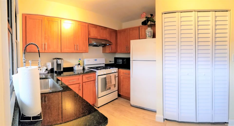 Well stocked kitchen with Keurig coffee maker, microwave, water filter and more