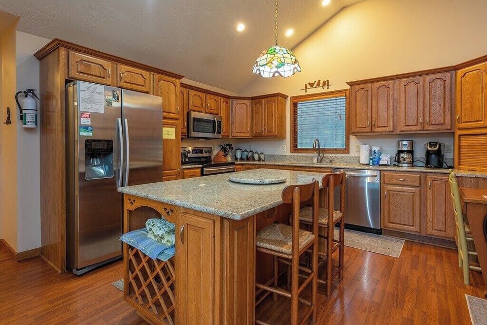 Large kitchen with stainless steel appliances and lots of counterspace, perfect for cooking meals!
