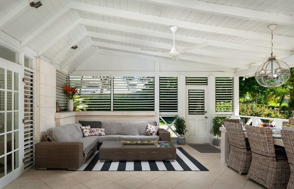 Undercover terrace with large sofa overlooking pool