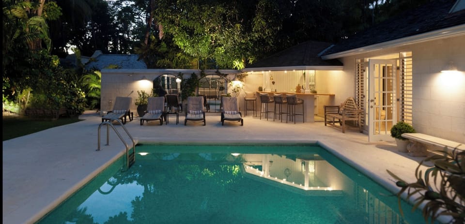 Pool at dusk from covered terrace 