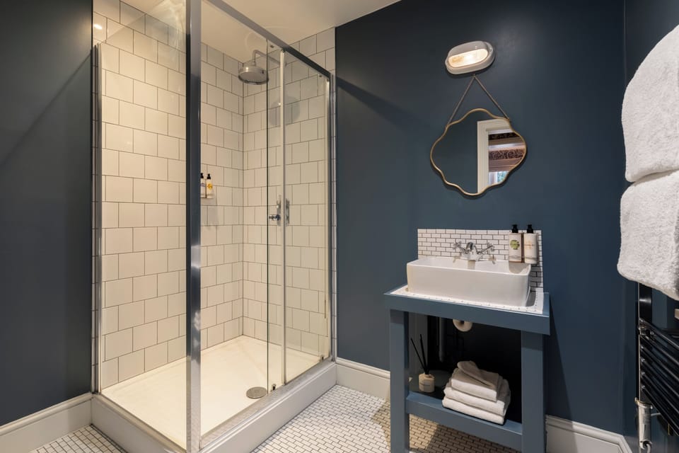 Shower, rainfall showerhead, hair dryer, towels