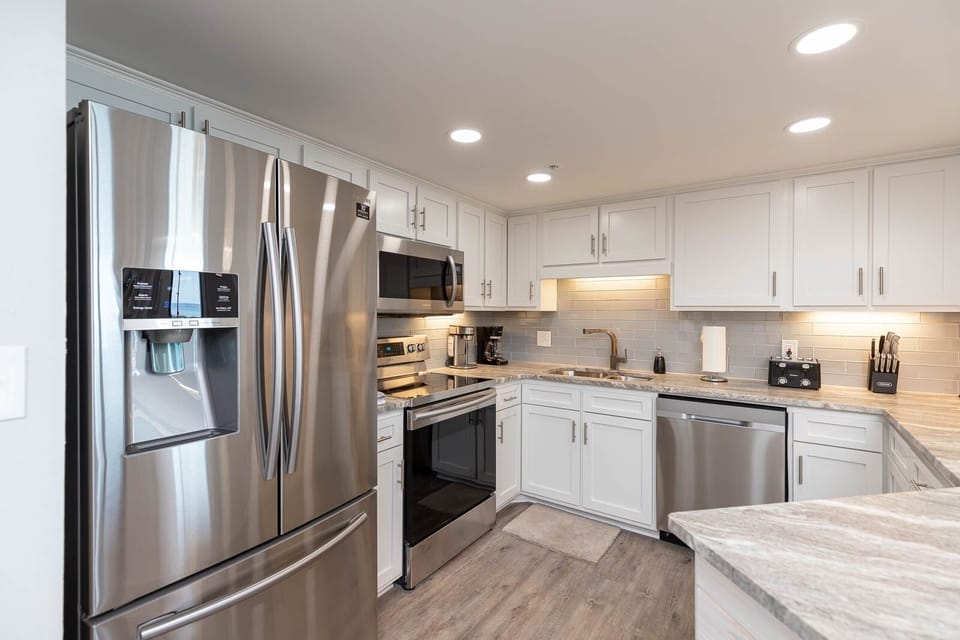 Prepare meals with ease in this stylish kitchen featuring stainless appliances and elegant countertops